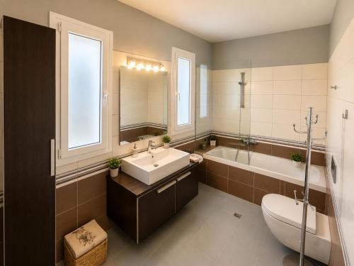 a bathroom with a sink and a tub and a toilet at Endless View Villa with Private Pool & BBQ in Daratso
