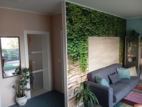 a living room with a couch and a green wall at Luxor4 in Kaštela