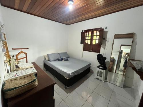 a bedroom with a bed and a mirror in it at Casa Gravatá Próximo ao Centro in Gravatá