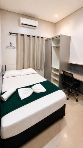 a bedroom with a bed with a desk and a bed sidx sidx sidx at Quarto 6 econômico próximo do aeroporto ar condicionado cama de casal in Marabá