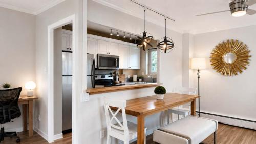 a kitchen and dining room with a wooden table and chairs at Downtown 1 BR Condo near Convention Center in Seattle