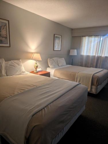 a hotel room with two beds and a window at Lakeside Motel in Williams Lake