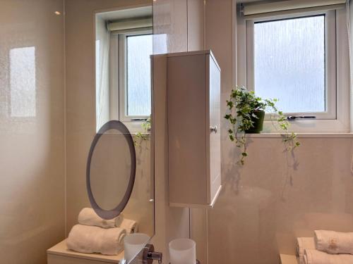 a bathroom with a mirror and a sink at Minch View Cabin 1 in Earlish