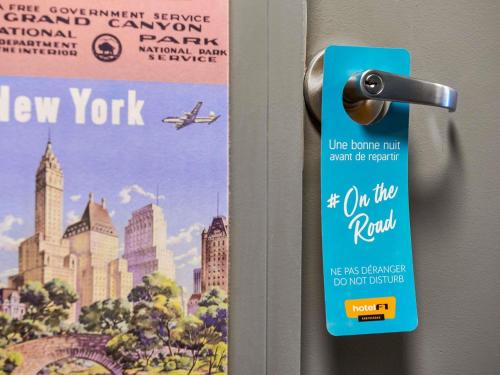 a door with a new york flyer on it at hotel F1 Vannes in Vannes