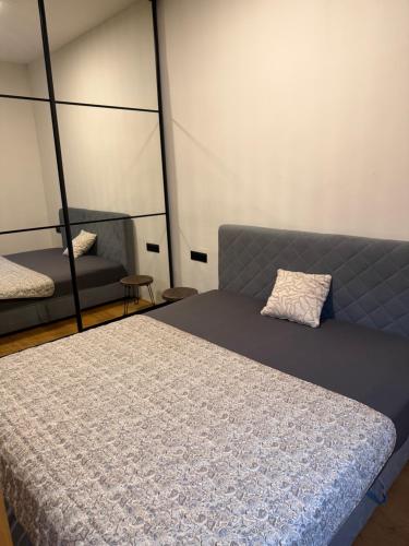 a bedroom with a bed and a couch at Studio apartment in Slezská Ostrava