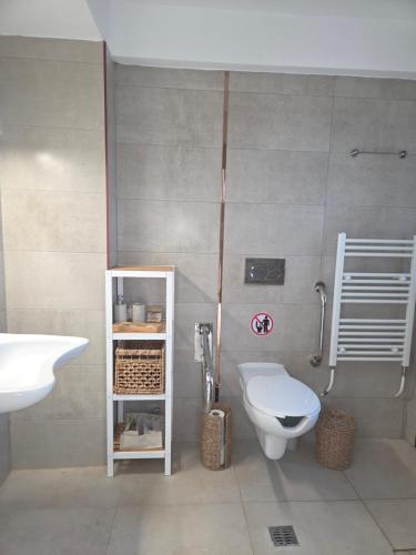 a bathroom with a white toilet and a sink at Asteria Houses Samothraki in Samothraki