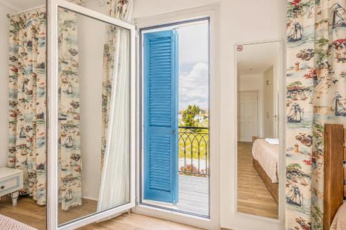 a room with a window with a view of a bedroom at Alaçatı Limonaia Hotel in Alaçatı