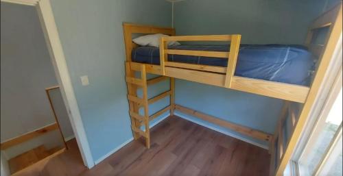 a small room with two bunk beds in it at Sendero de Luna in Valdivia