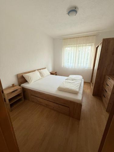 a bedroom with a large bed and a window at Una Relax Apartment - Naturally Cool - North-Facing - Near the River in Bosanska Krupa