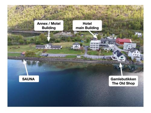 a map of a town with buildings and a body of water at Hjelle Hotel in Hjelle