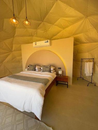 a bedroom with a bed in a tent at Bedouin Camp&tour in Wadi Rum