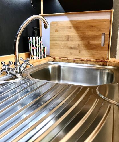 a stainless steel sink in a kitchen at Eleana Apartments in Hersonissos