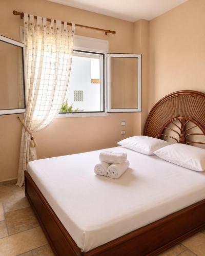 a bedroom with a bed with two towels on it at SunsetApartment in Siviri