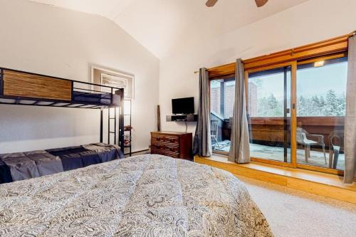a bedroom with a bed and a large window at Pico Mountain Perch, Unit B22 in Mendon