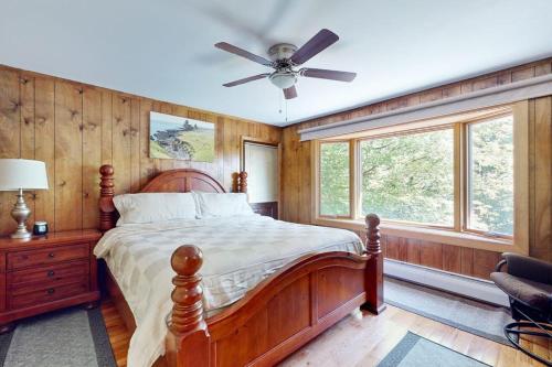 a bedroom with a bed and a ceiling fan at Killington's Hideaway in Killington