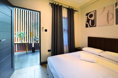 a bedroom with a bed and a sliding glass door at Locale District Boutique Hotel in Quezon