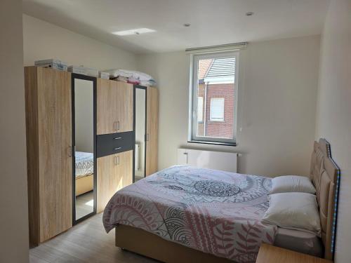 a bedroom with a bed and a large window at Maison Élégante - Space & Comfort Vilvoorde in Vilvoorde