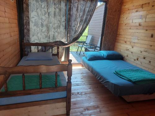 a bedroom with two bunk beds in a cabin at Apartman Dva Dječaka in Ulcinj