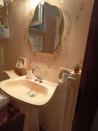 a bathroom with a sink and a mirror and a toilet at Akratas Brothers House in Akrata
