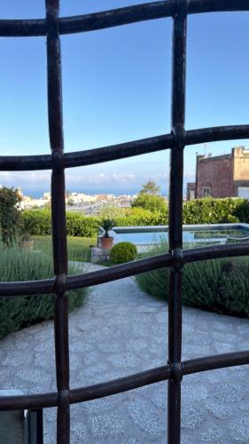 a view through a barred window of a garden at Amamì B&B in Anacapri