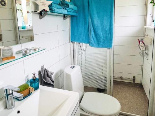 a bathroom with a toilet and a sink and a mirror at 4 star holiday home in SÖLVESBORG in Sölvesborg