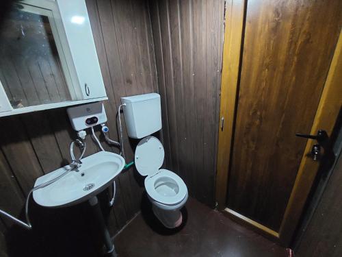 a bathroom with a white toilet and a sink at Kućica Dva Dječaka in Ulcinj
