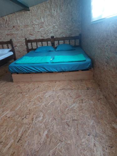 a bed in a corner of a room at Kućica Dva Dječaka in Ulcinj