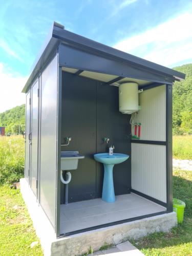 a shed with a toilet and a sink in it at Kamp SAN in Zaglavica