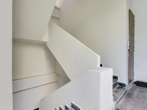 a white staircase in a room with a door at Hotel O Hills Land in Warangal