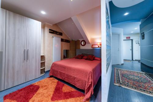 a bedroom with a bed with a red bedspread at AuraVista in Montefiascone