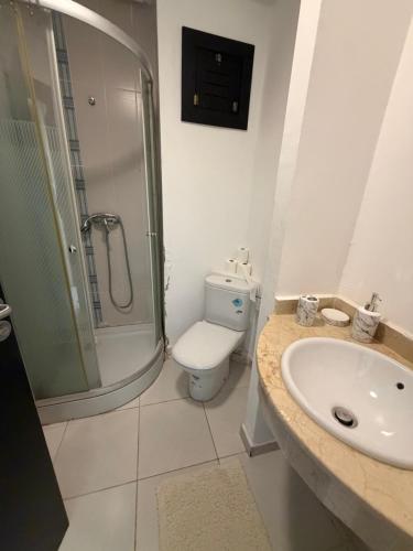 a bathroom with a sink and a toilet and a shower at Superbe Appartement Bord de mer in Bouznika