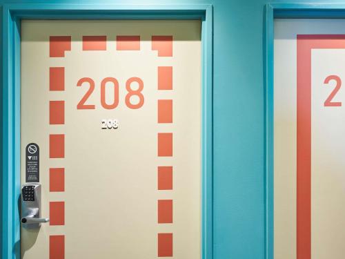 a door with numbers on it in a elevator at Ibis budget Brest Sud Plougastel - Hôtel rénové in Plougastel-Daoulas