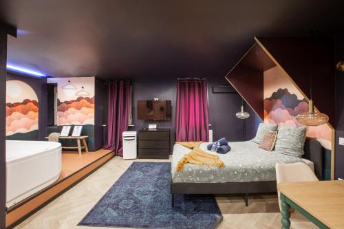 a bedroom with a large bed and a bathroom at Doux Pavillon - 1001 nuits - Jaccuzi in Mulhouse