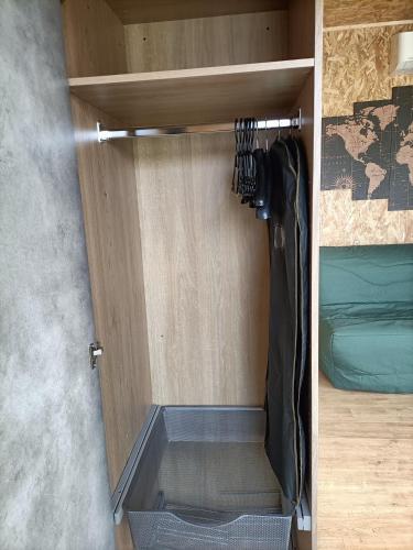 an open door of a room with a bed at La cabane des jours heureux in Saint-Laurent-de-Carnols