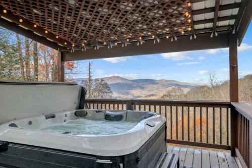 a hot tub on a deck with a view at Meadow View in Banner Elk