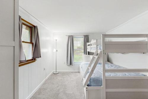 a bedroom with two bunk beds and a window at Cozy Dennis Retreat in Bridgewater