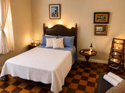 a bedroom with a large bed with blue pillows at Loft no Hotel Quitandinha Experiência Única in Petrópolis