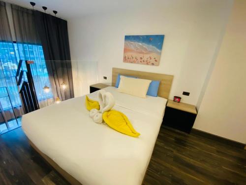 a bedroom with a bed with bananas and a stuffed animal on it at Utopia Loft in Rawai Beach