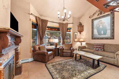 a living room with a couch and a fireplace at Telemark Lodge #504 in Copper Mountain
