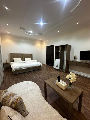 a living room with a bed and a coffee table at غرف خاصة مودرن in Hail