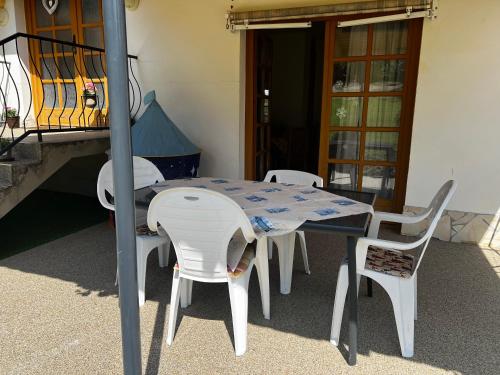a table and chairs sitting on a patio at Relax Apartment House in Zalakaros