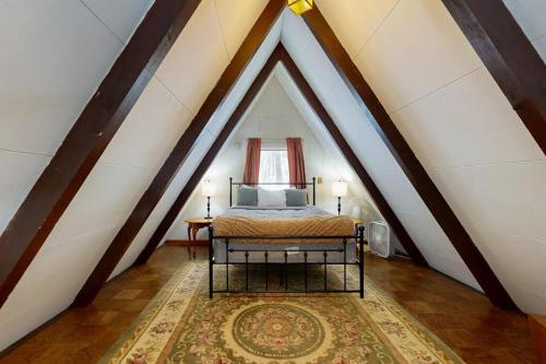 a bedroom with a bed in a attic at A-Frame Escape in Ludlow