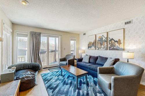 a living room with a couch and a table at Okemo Mountain Lodge A208 in Ludlow