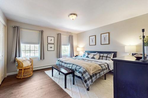 a bedroom with a bed and a chair in it at Kindred Hollow in Ludlow