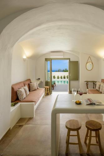 a living room with a couch and a table at Kaminia Holiday Homes in Éxo Goniá