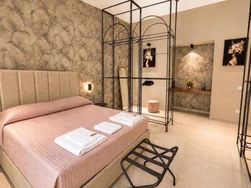 a bedroom with a bed with two towels on it at Donna Sofia in Torre Annunziata