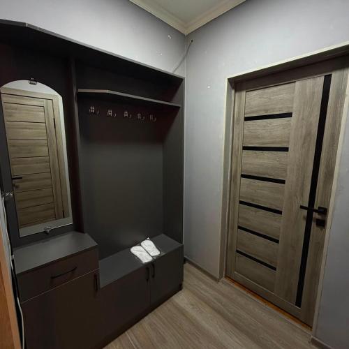 a bathroom with a sink and a mirror and a closet at Three Star in Almaty