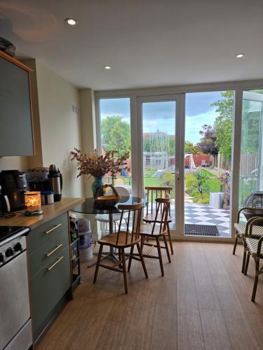 a kitchen with a table and chairs and a view of a patio at Margate beach house in Margate