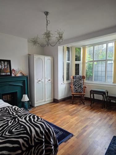 a zebra themed bedroom with a bed and a chair at Margate beach house in Margate
