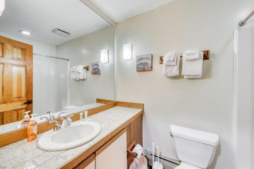 a white bathroom with a sink and a toilet at Sunrise - East Glade-C7 in Killington